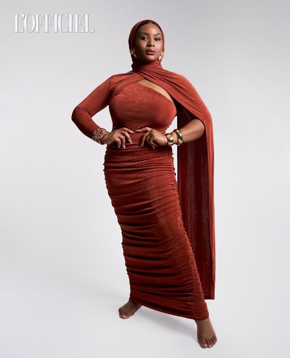 Rust draped dress on a pale ground