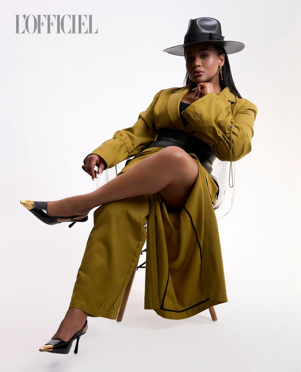Olive coat and black hat, seated