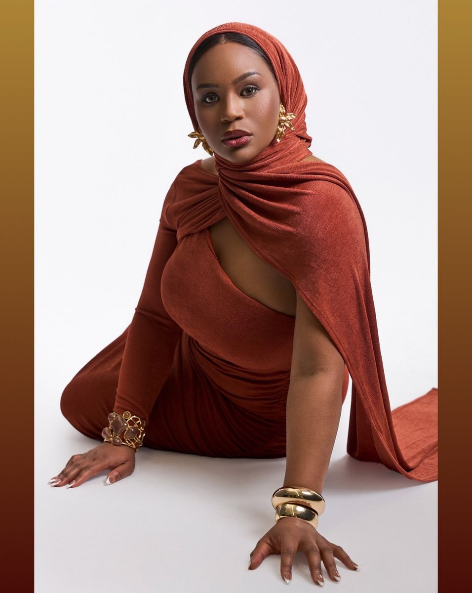 Rust draped dress, seated on the floor